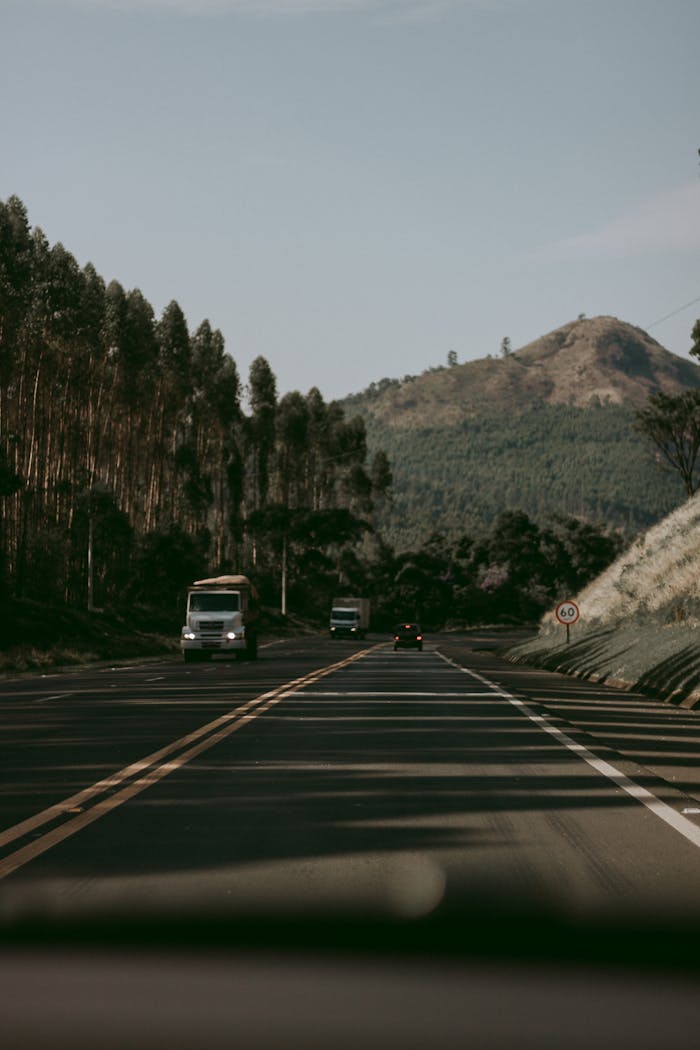 Selective Focus Photo of Vehicles on the Road